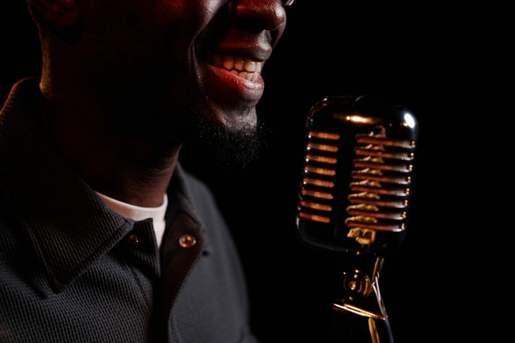Close Up of Smiling Black Man Speaking to Mic