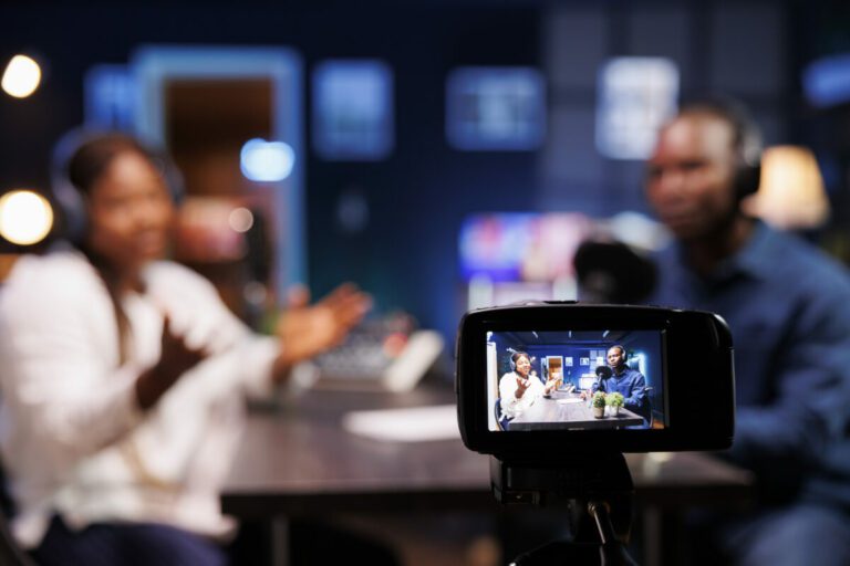 Device on a tripod filming a talk show