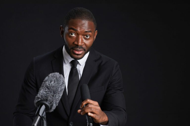 African American Man Speaking to Microphone